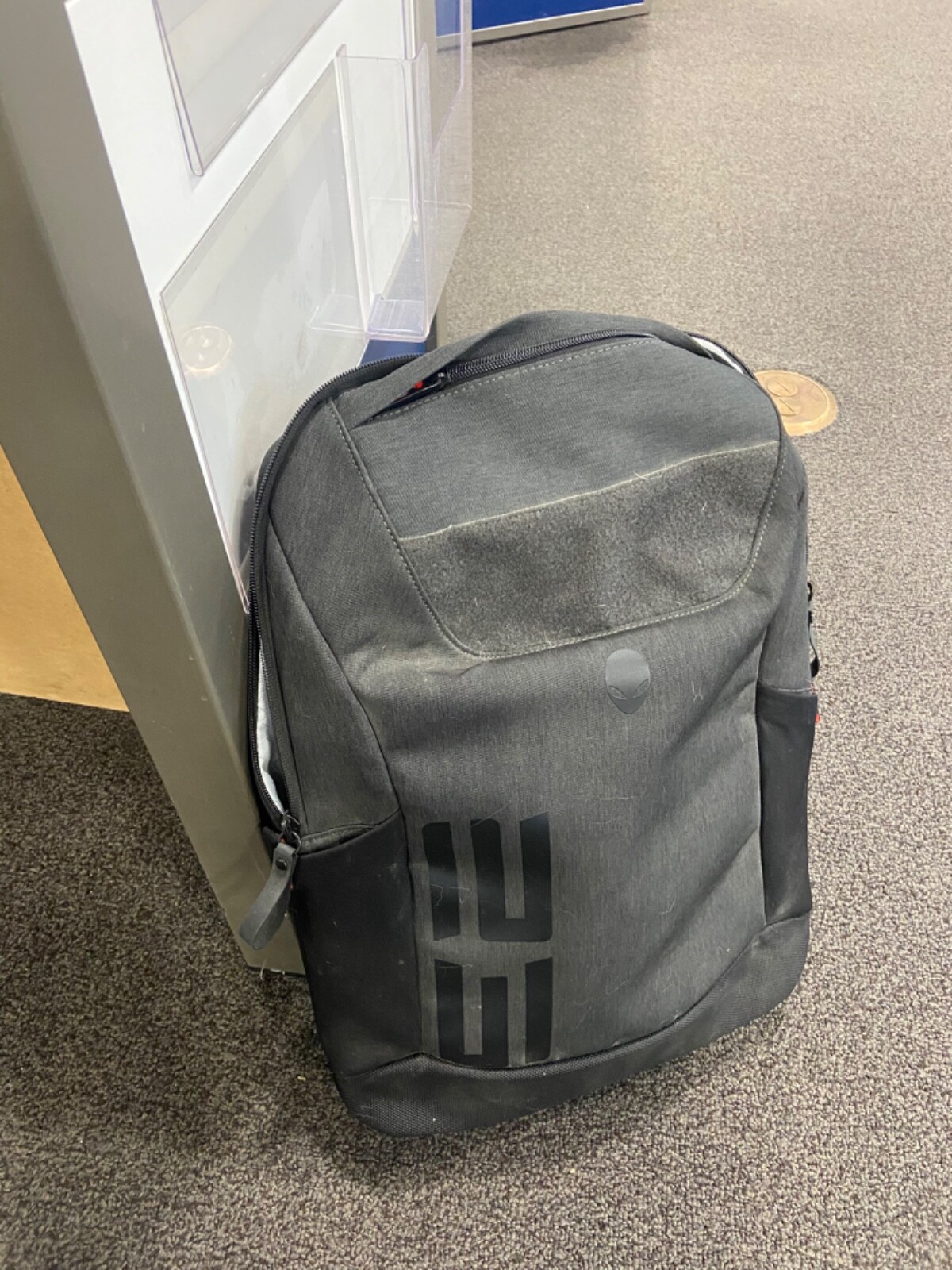 Alienware M17 Laptop with charger and backpack.