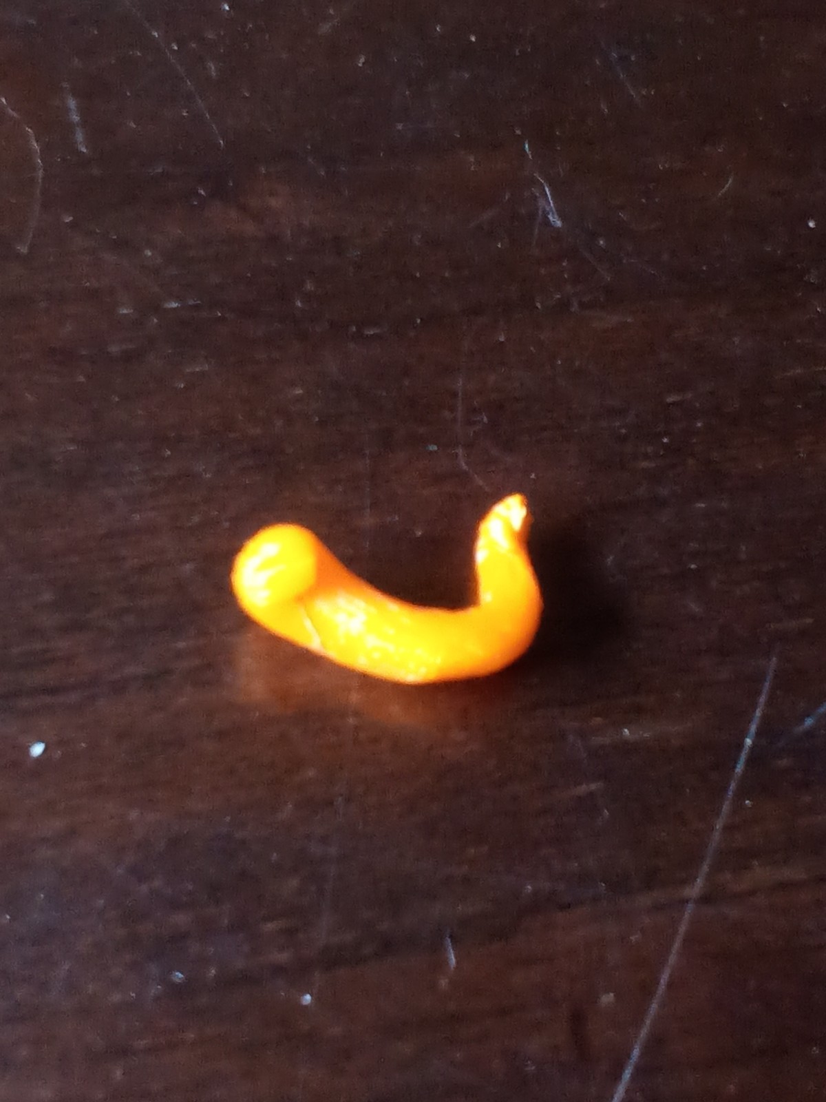 a small orange bell pepper found inside a large bell pepper with a sprout