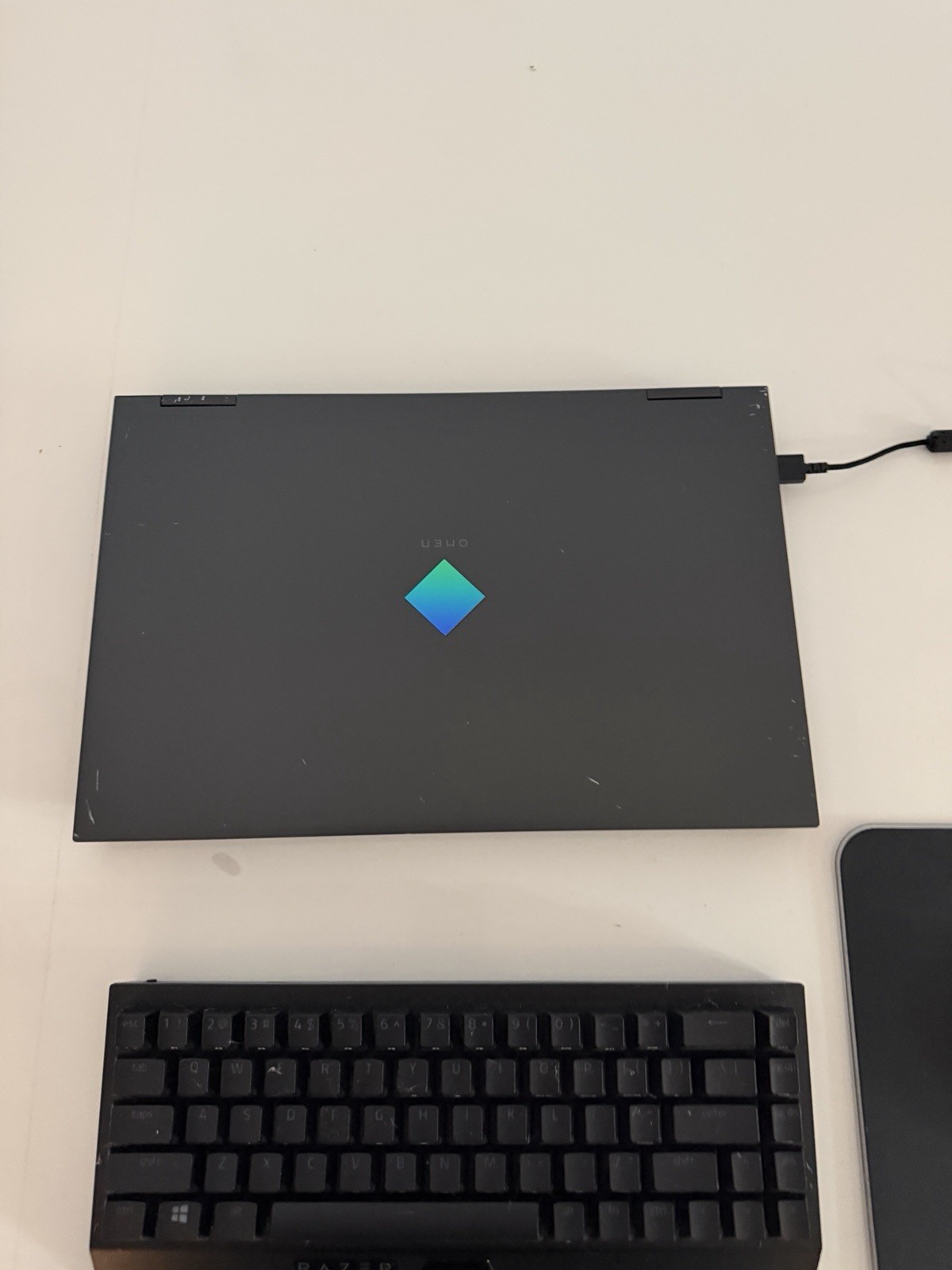 Omen 15 laptop with Razer Mouse, Razer Mousepad, Razer Keyboard, and charger.